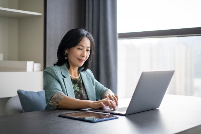 Woman at desk working on laptop